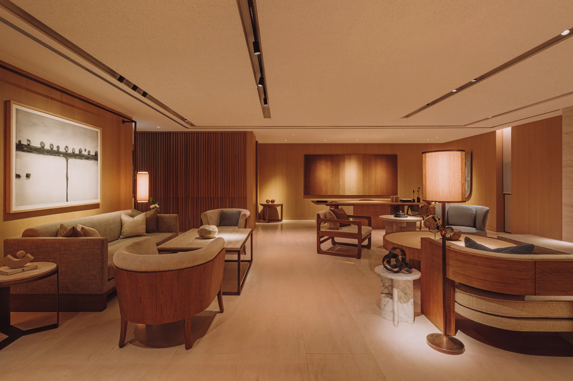 The first-floor PLAYA Lounge, lounge chairs and low tables across an open floor