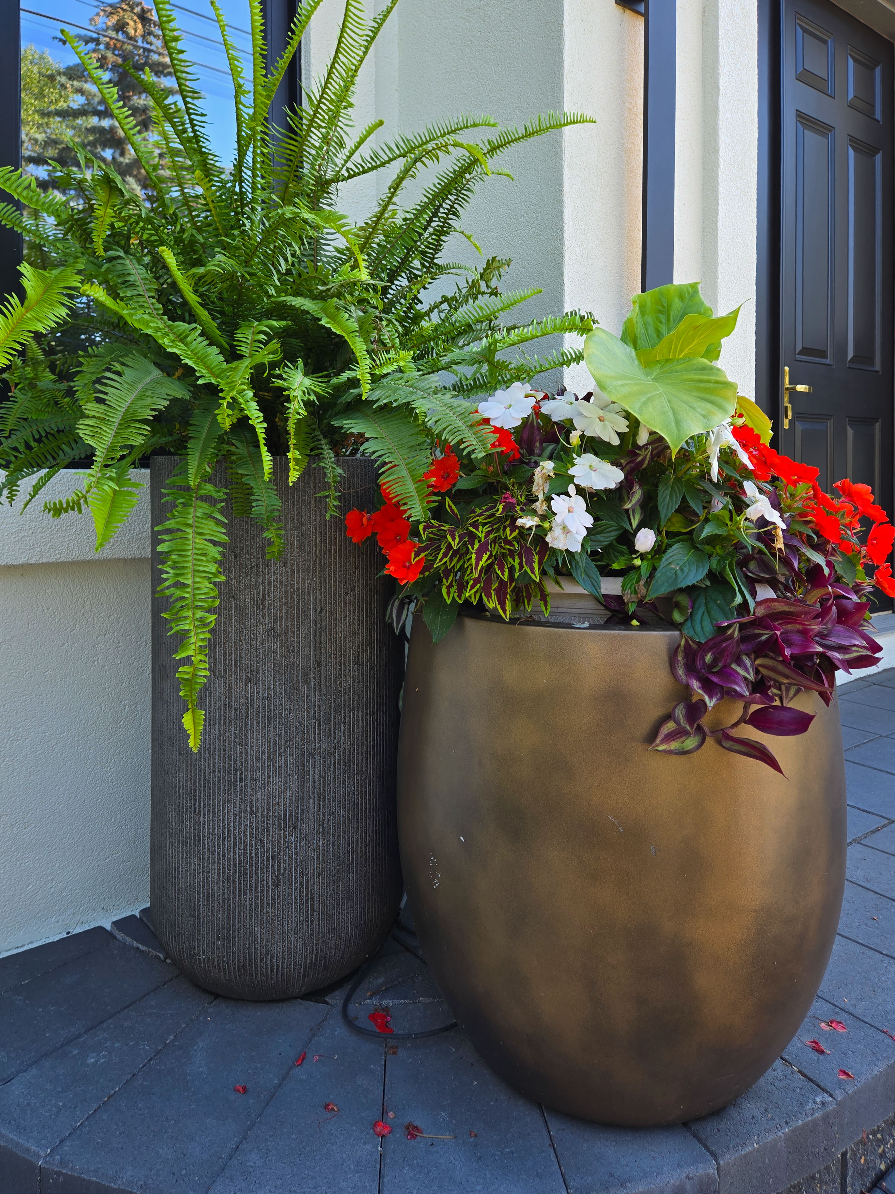 Image of Luxury home exterior with large planters and flowers, KHD Homes design-build construction and interior design.