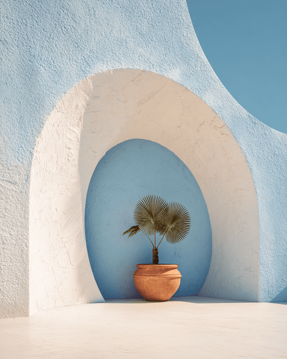 Smiling young man with short hair poses against a dark background, wearing a green button-up shirt.