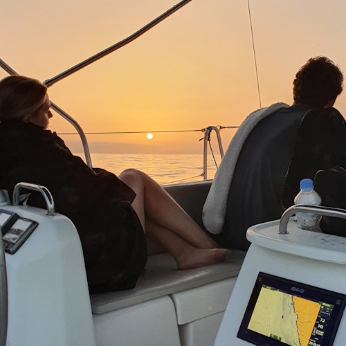 Couple enjoying the sunset on our boat