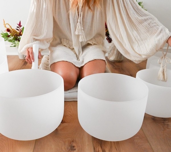 A woman receives a relaxing energy healing in a serene setting with soft lighting.