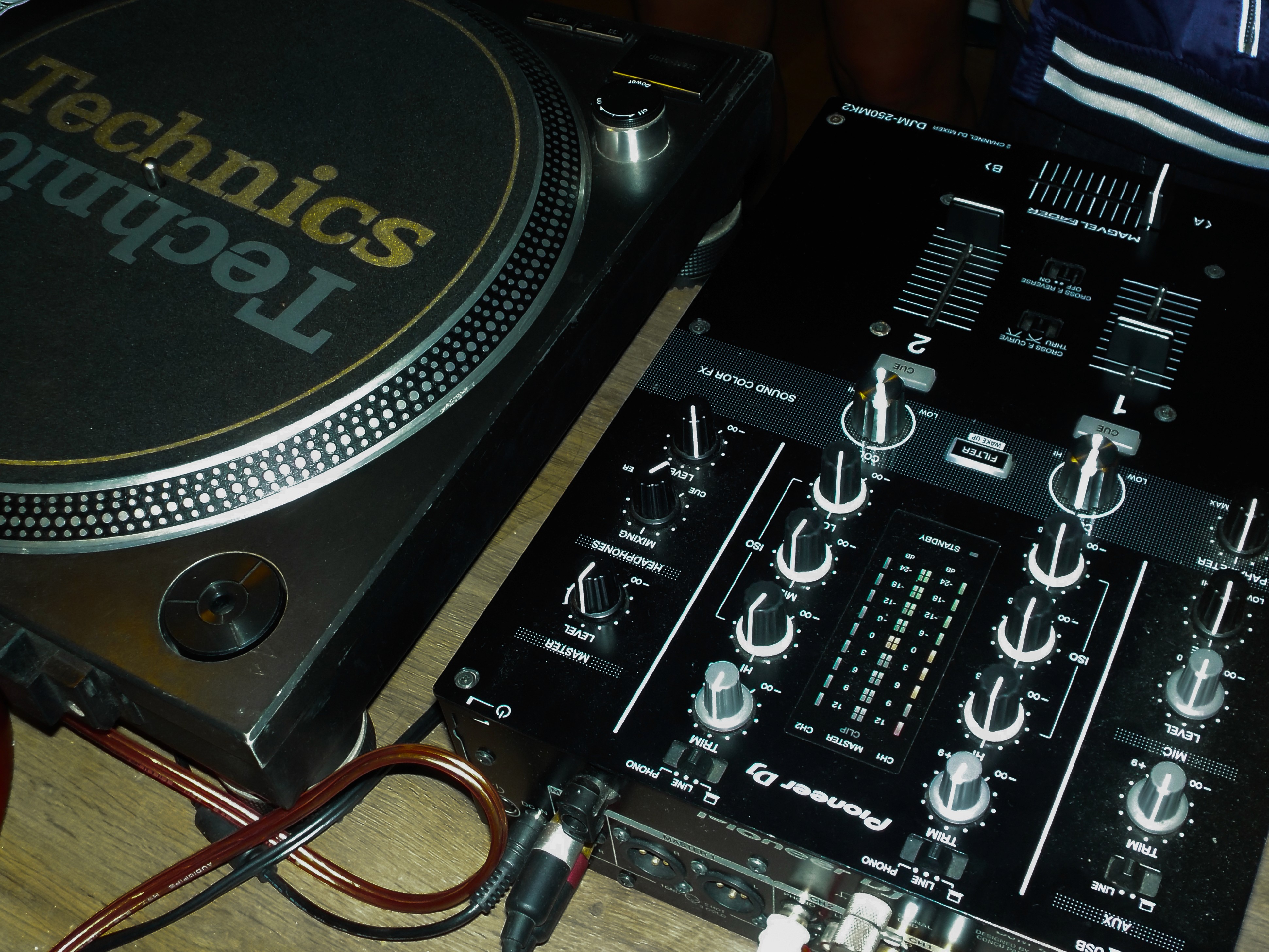 close-up view A modern art museum with a minimalistic and warm aesthetic. The scene features a pedestal in the center displaying an elegant perfume bottle as a work of art. The walls are textured in warm beige tones, and the floor is made of smooth, dark stone or polished cement. Soft natural light streams in through a large, unseen window, casting long, warm shadows across the floor and pedestal. The atmosphere is intimate and contemplative, with the perfume bottle illuminated gently by the sunlight, emphasizing its artistic significance. The background is clean and spacious, with no distractions, creating a harmonious and organic balance in the composition