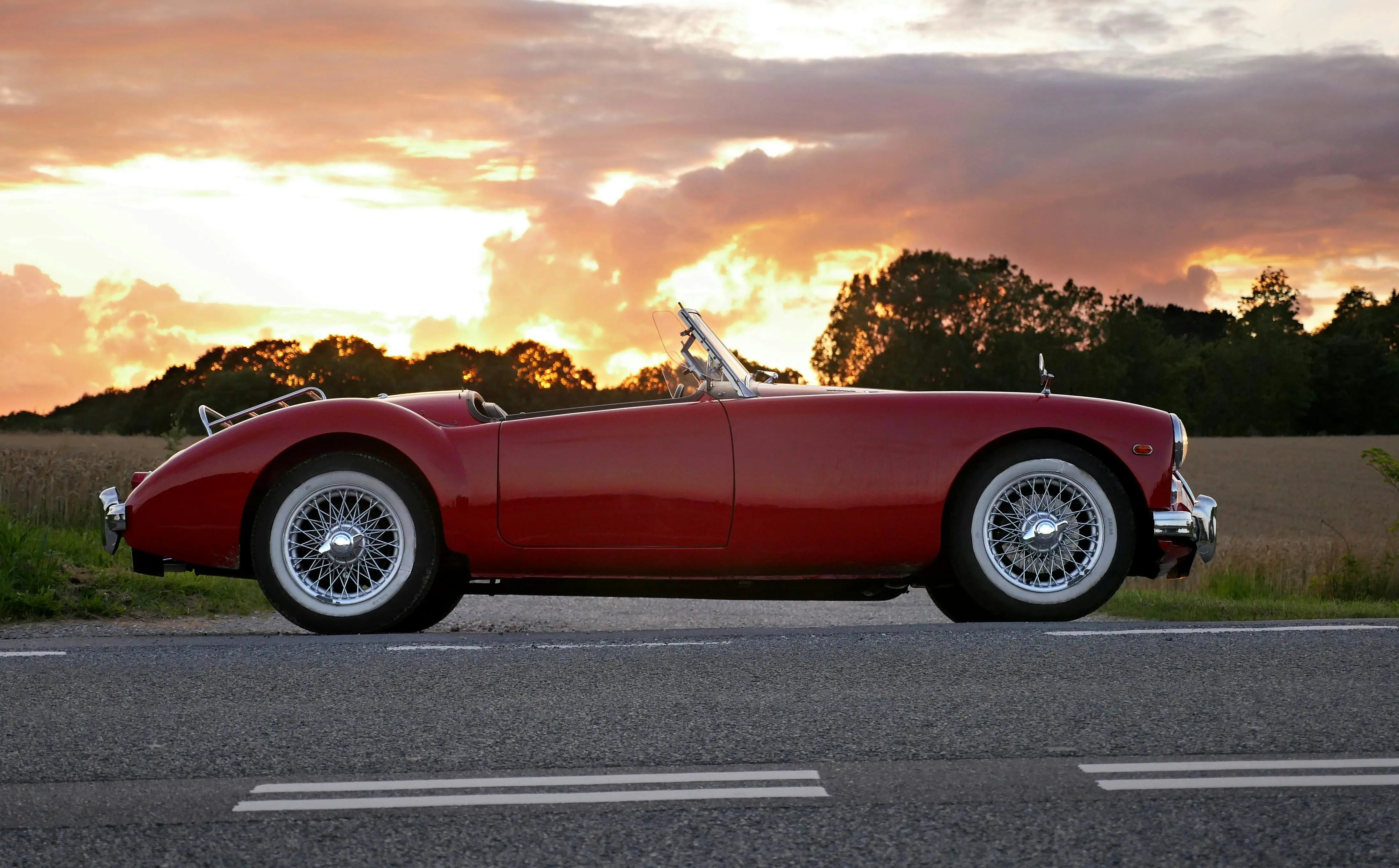 Vintage red MG convertible, symbol of British charm and timeless roadster spirit — restored with passion for conscious driving.