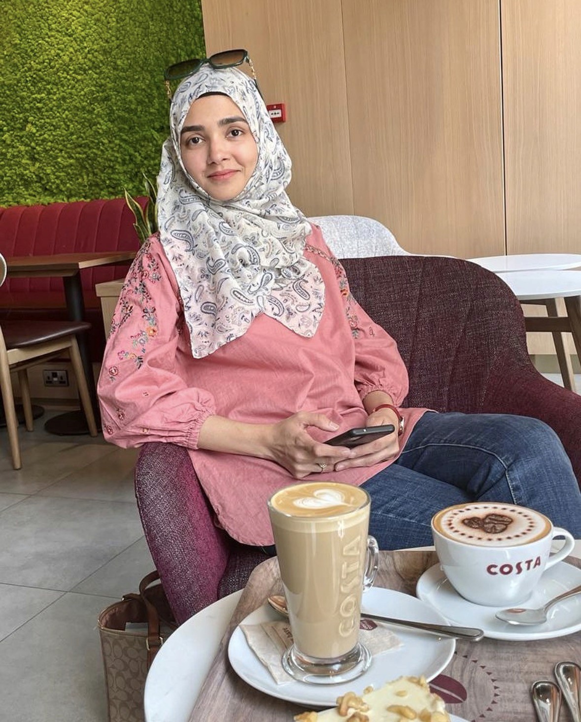 A person in a white shirt black coat with the fair skin looking infront