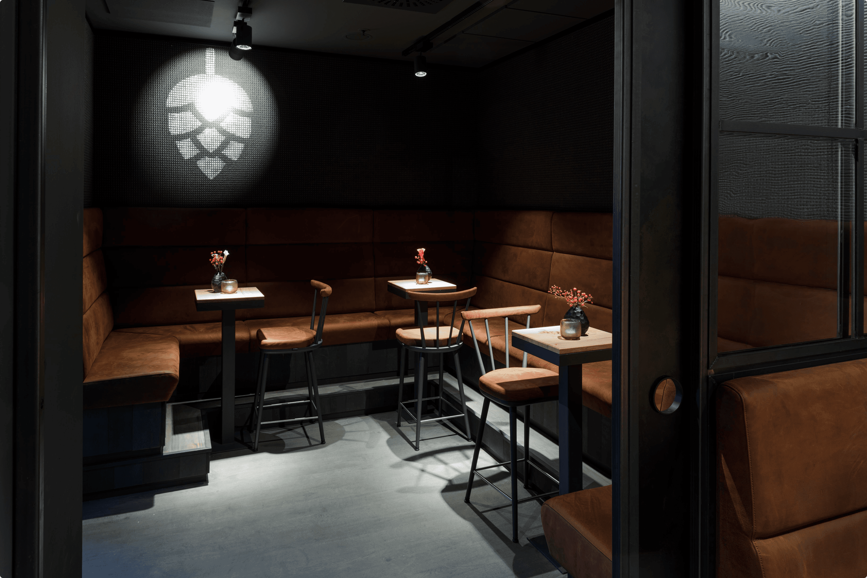 Modern booth seating with tables and chairs.