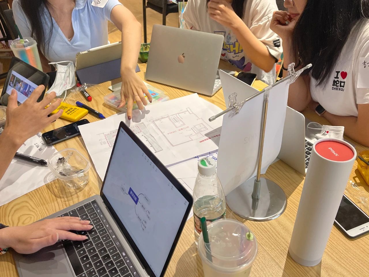 Collaborative brainstorming session with laptops and papers