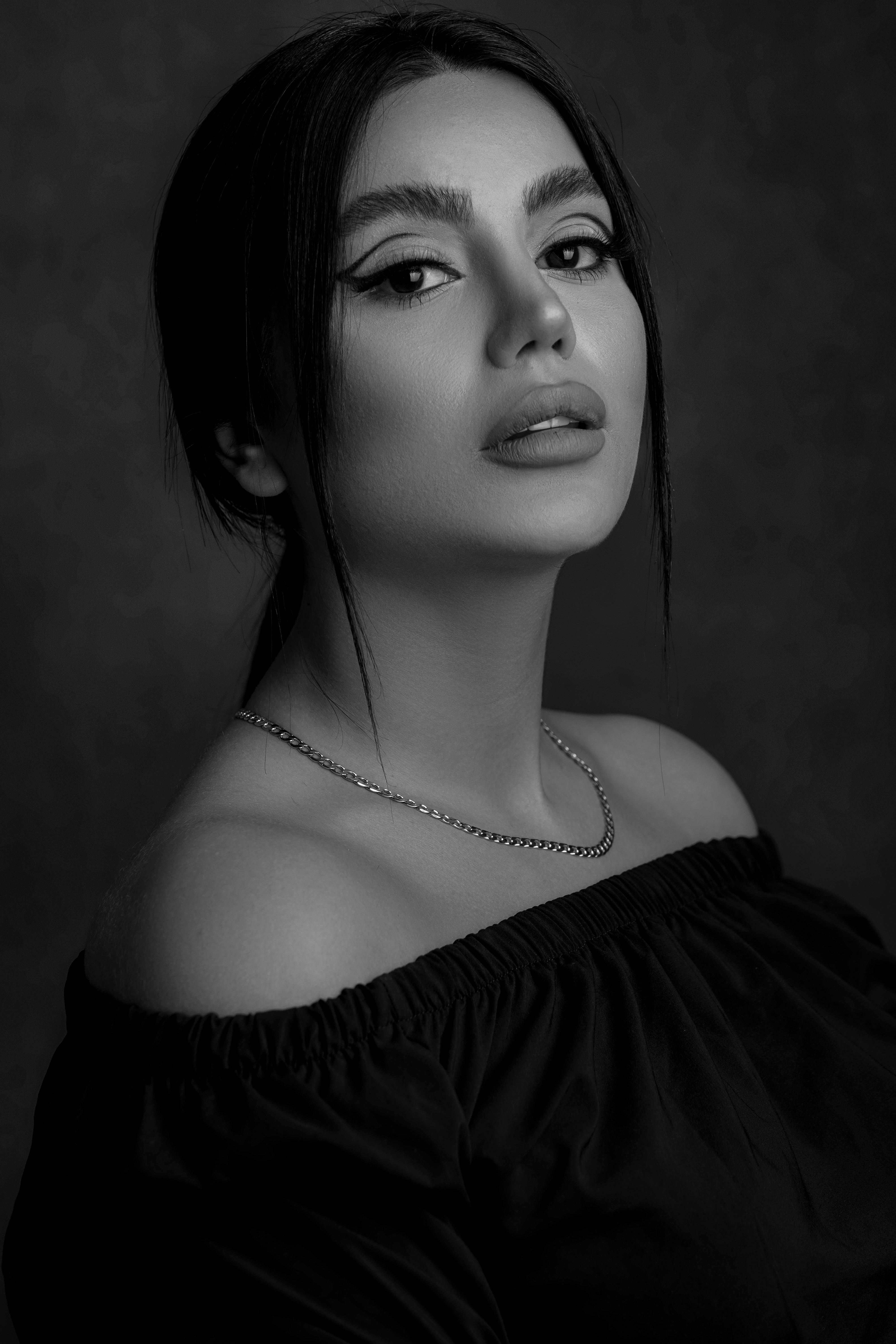 a woman in a black dress posing for a picture
