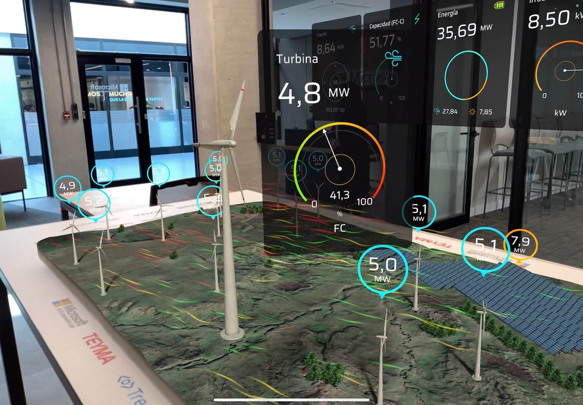 Augmented reality wind farm digital twin showing live turbine output in megawatts beside wind, capacity and energy dashboards