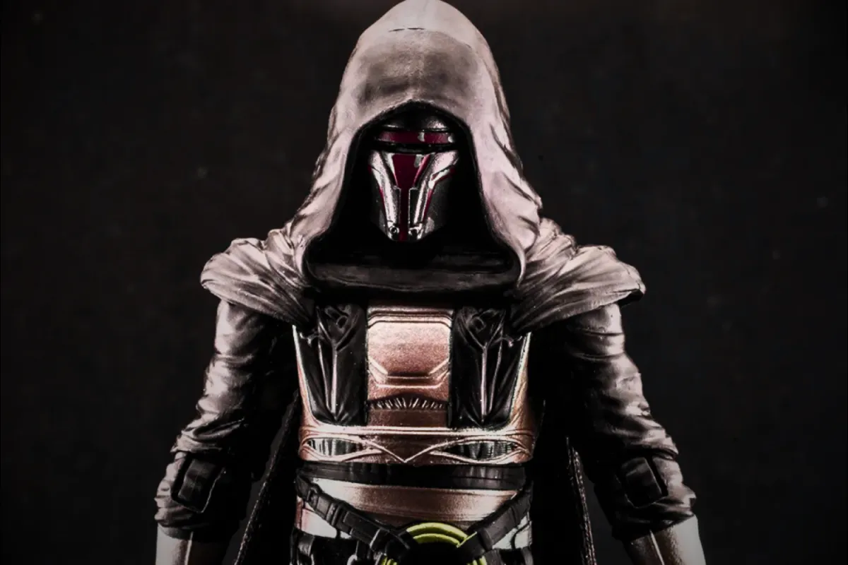 A close-up view of the Darth Revan Black Series action figure by Hasbro. The figure depicts Revan wearing his signature dark hooded cloak and intricately detailed armor, with his iconic red and black Mandalorian-inspired mask. The craftsmanship highlights the character’s menacing and enigmatic presence.