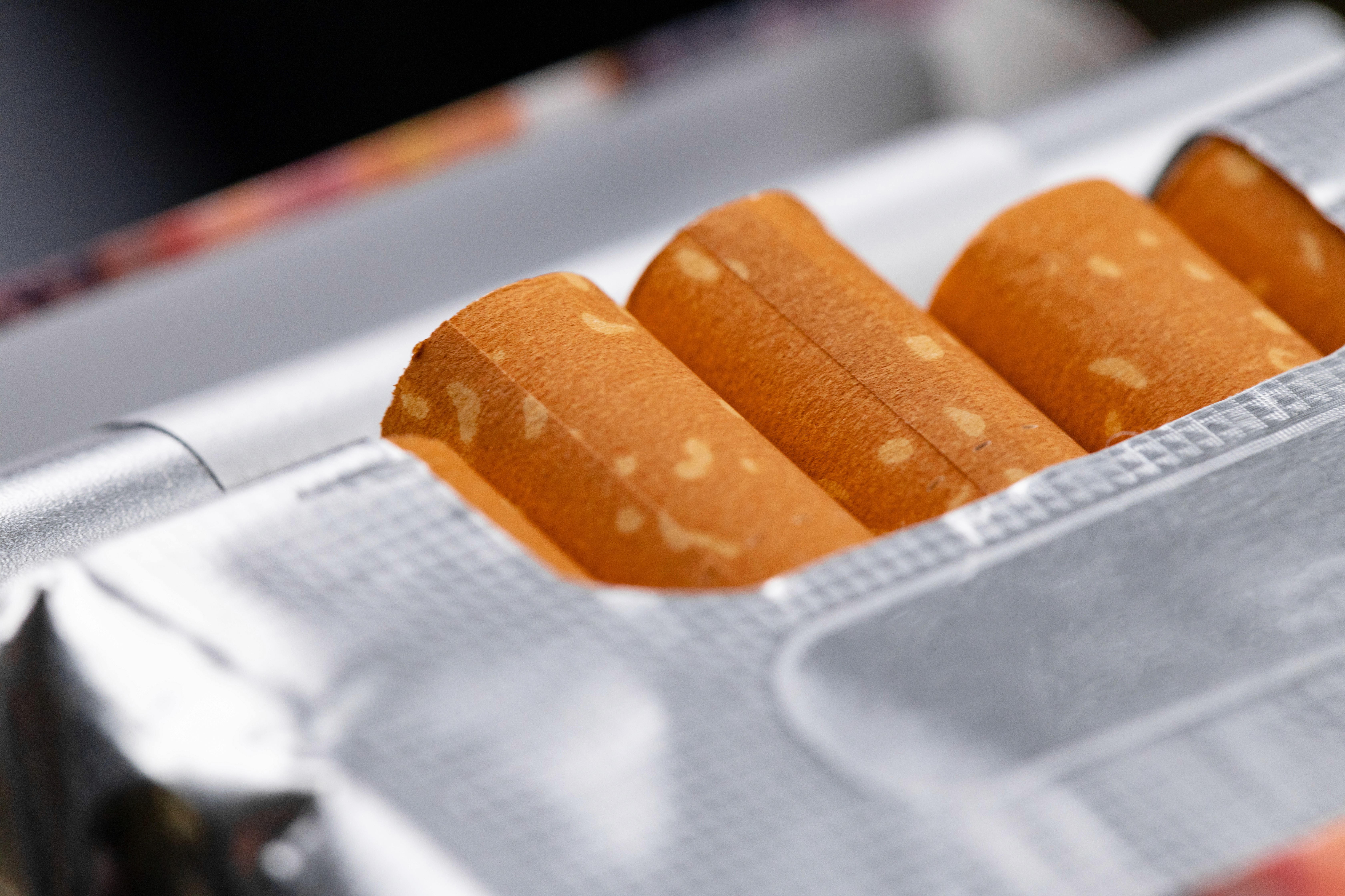 A man stading with Surfboard