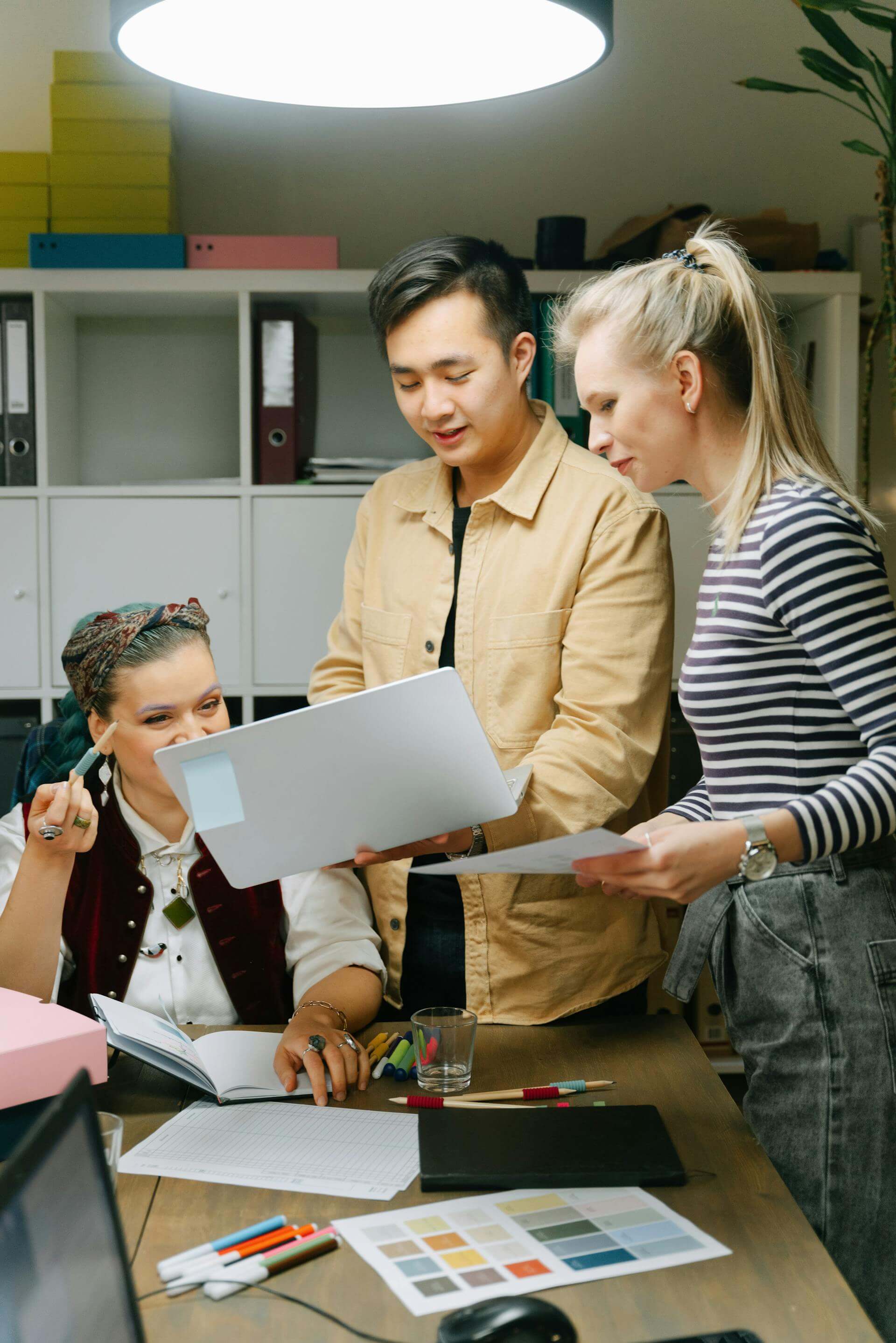 team members discussing and looking at the laptop