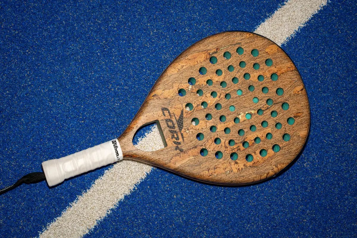Cork padel racket on indoor court surface