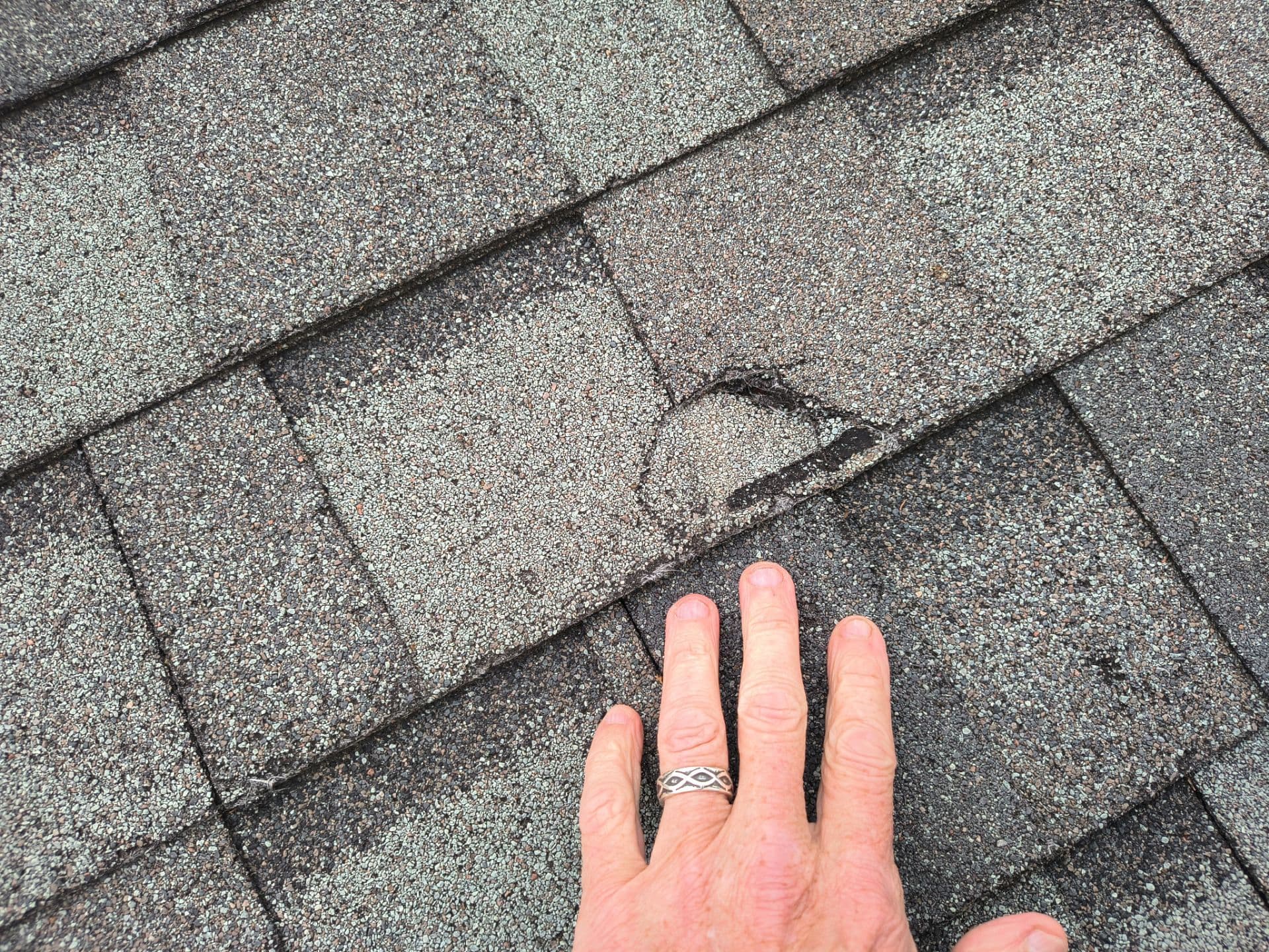 Hail damage assessment on an Oak Cliff home after a North Texas storm