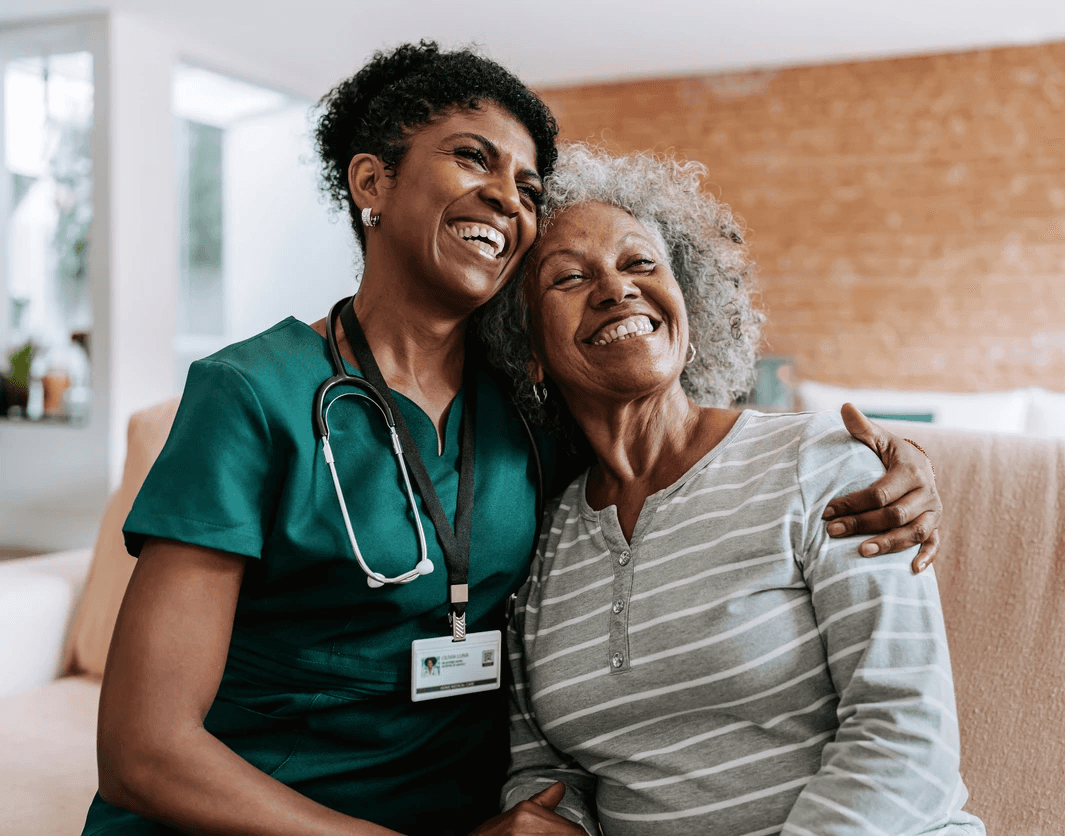 Senior healthcare worker and happy senior woman