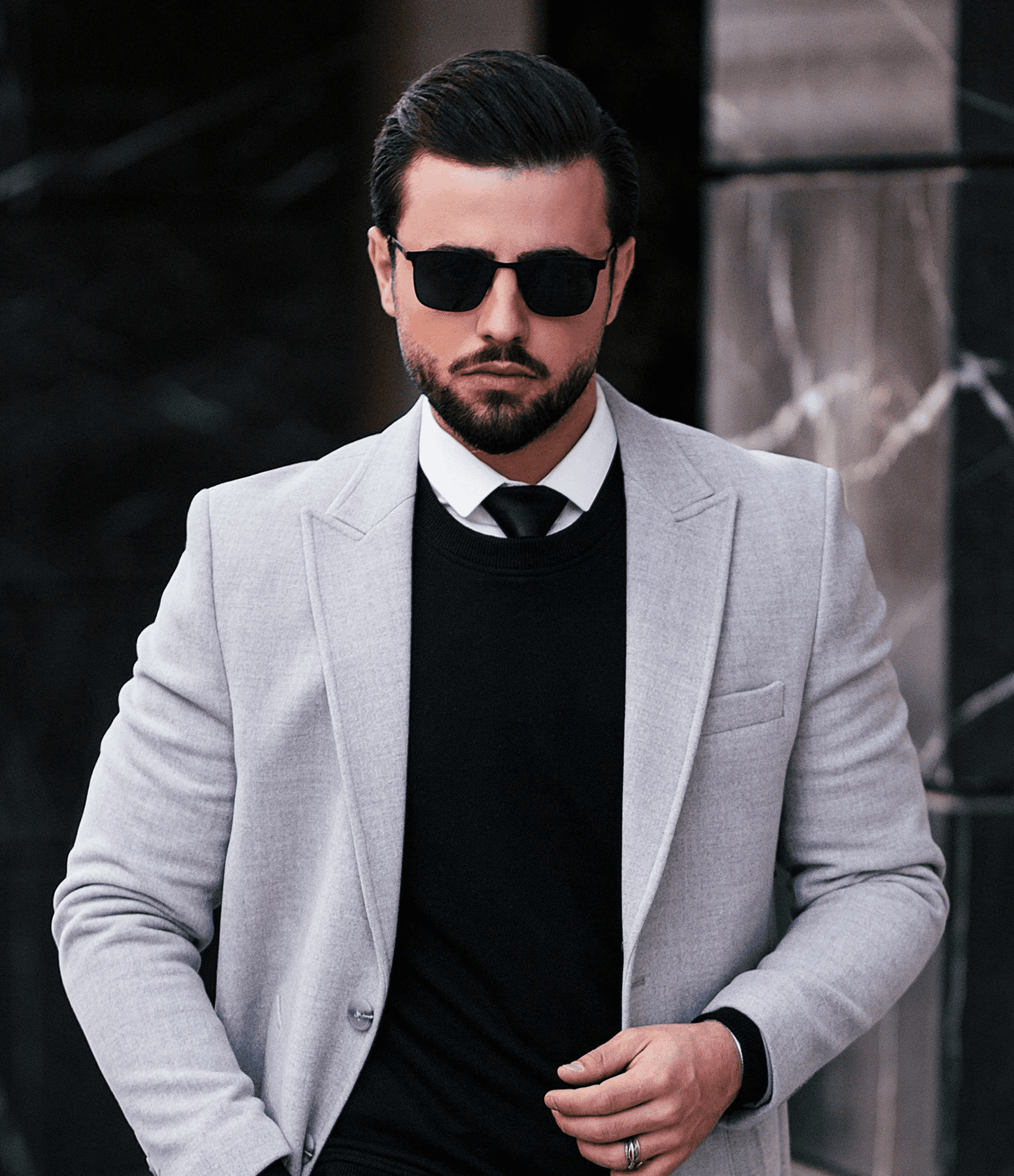 a man in a suit and tie standing on a sidewalk