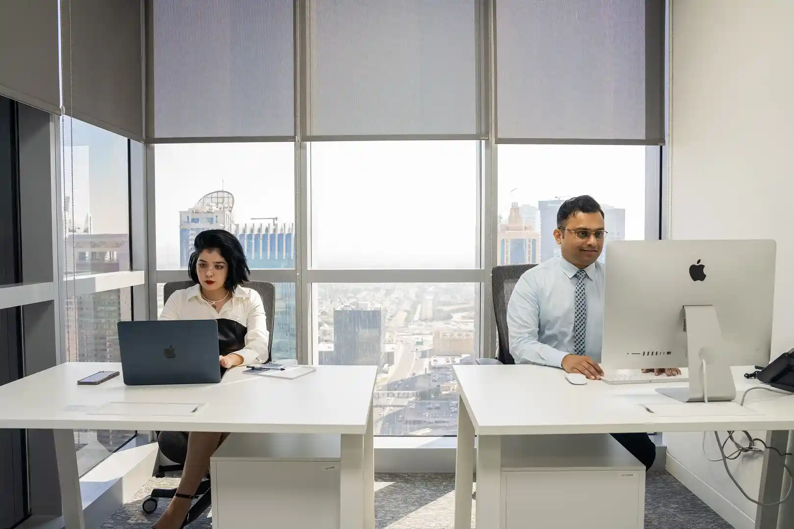 Professionals working in a private office at a myOffice business centre in Dubai