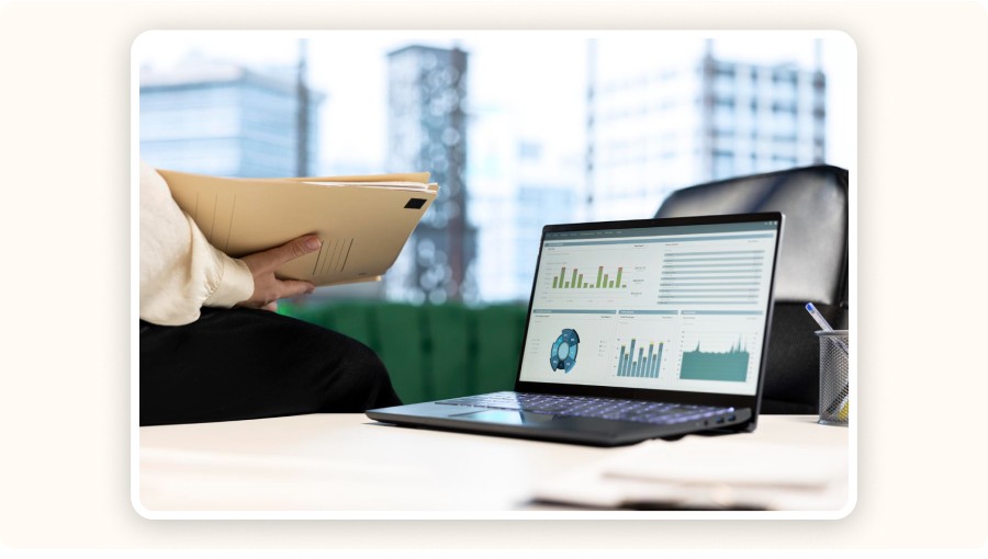 Person reviewing analytics dashboard on laptop with reports and performance charts