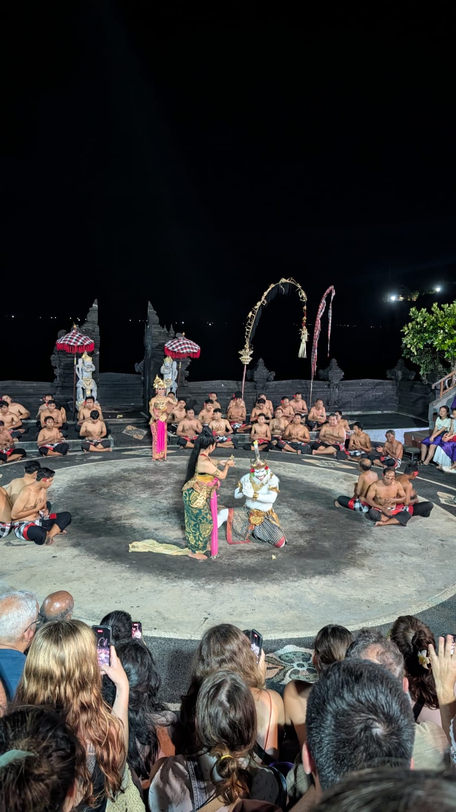 silhouette of man and woman holding fishing rod standing on dock during sunset