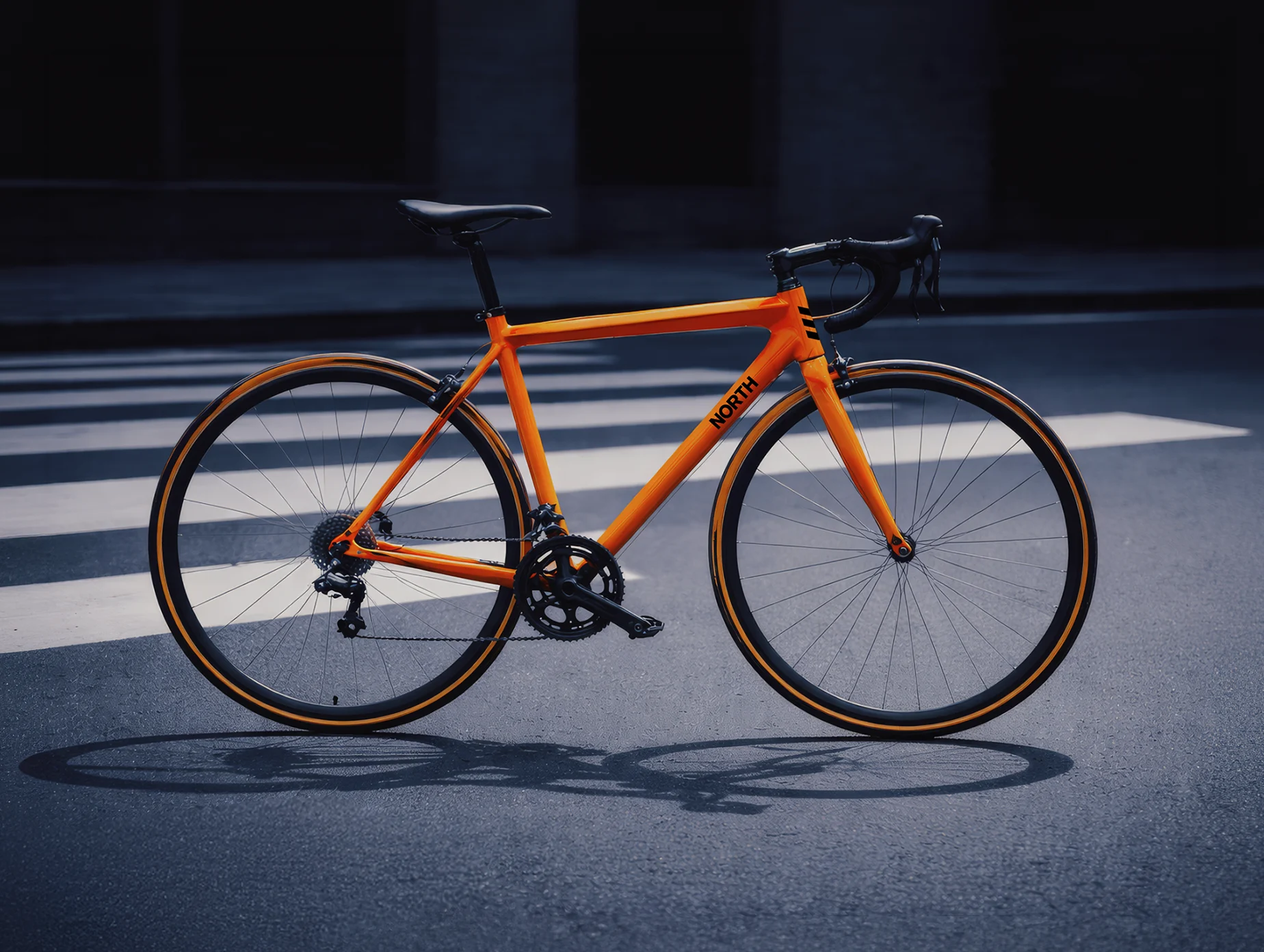 Side profile of an orange North road bike positioned on a city street.