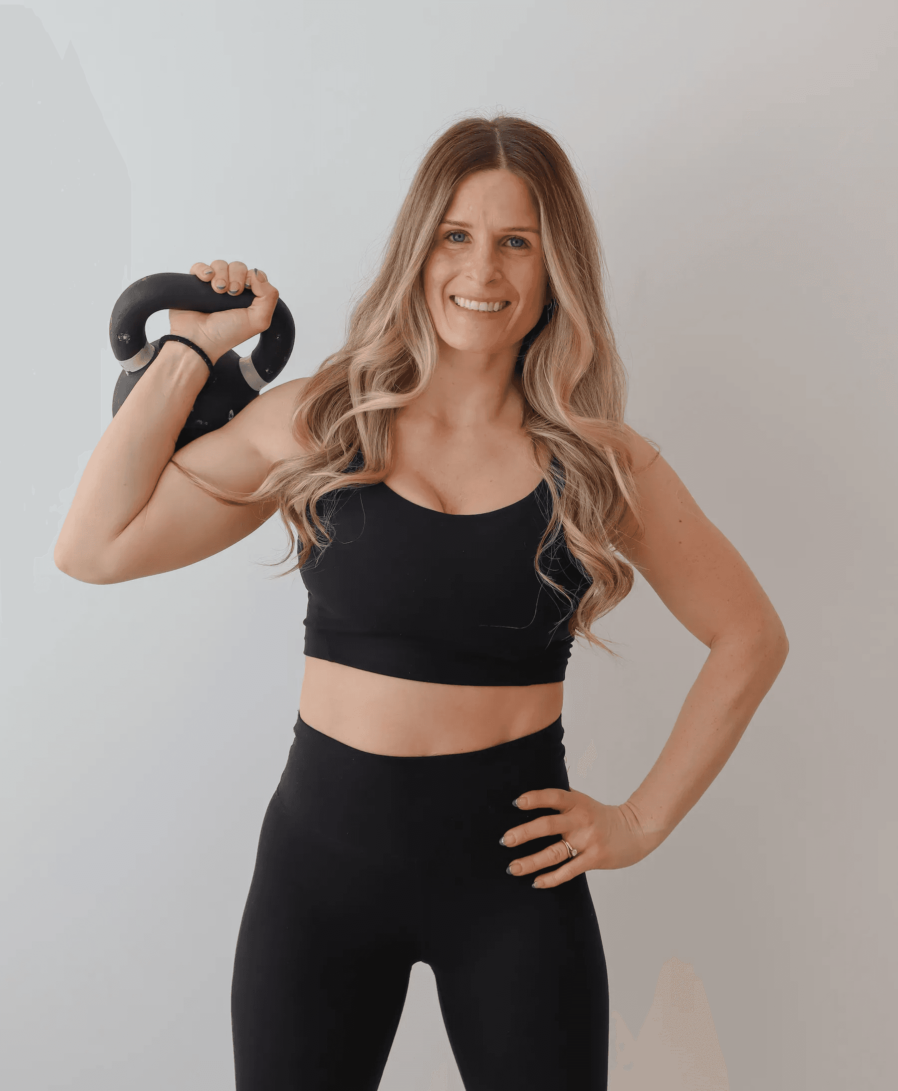 Alanna holding a kettlebell for a Rise Within Fitness strength and mobility class in Barrie