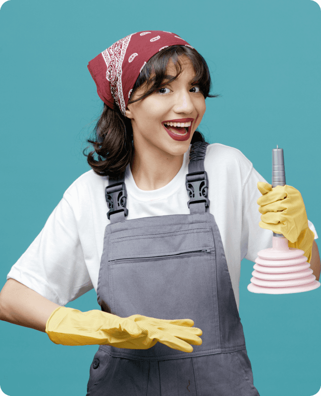 Happy female cleaner holding a pink plunger and wearing yellow gloves, smiling brightly against a vibrant blue background, showcasing a fun side of cleaning.