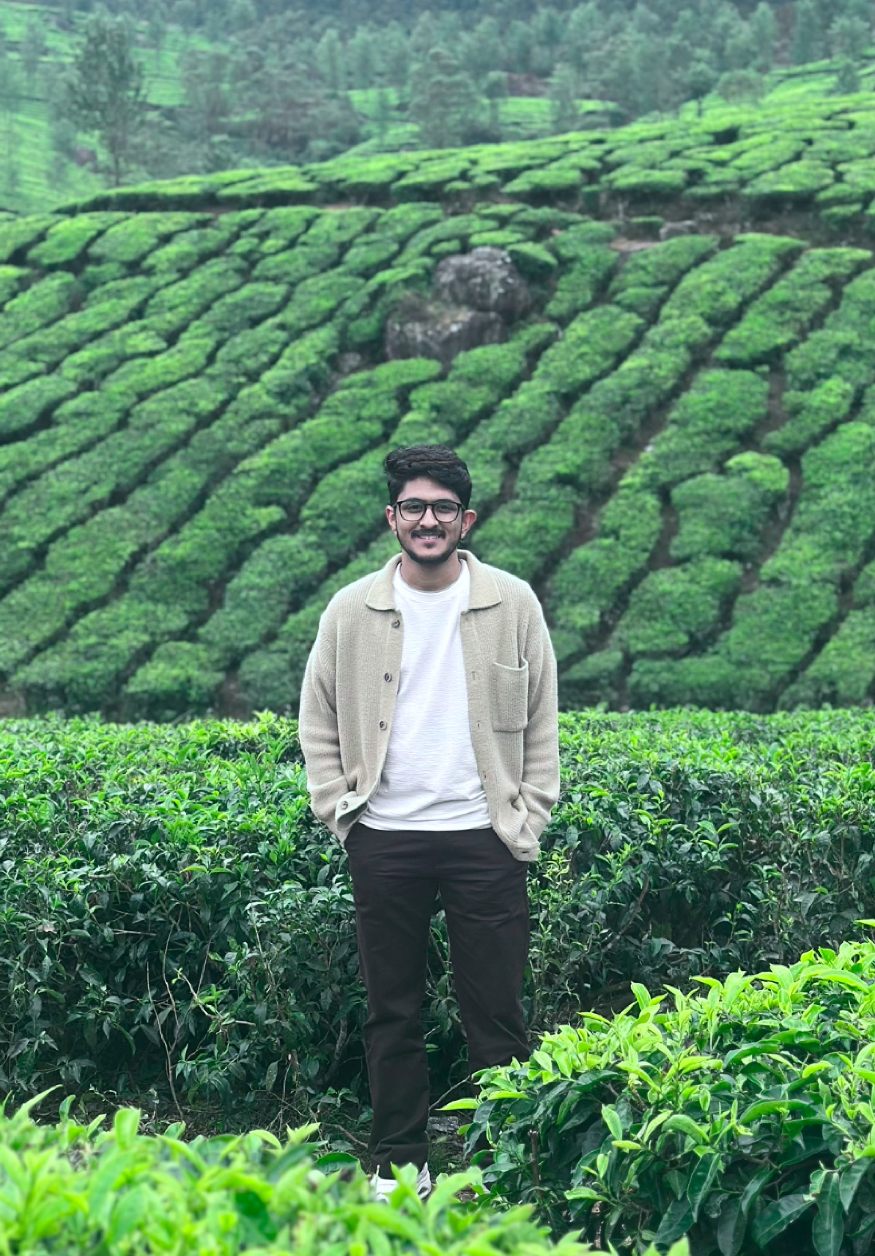 Gagan standing among tea plants.