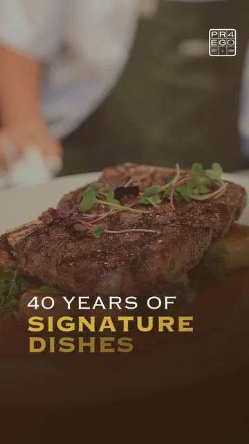 A steak on greens, under the words “40 years of signature dishes”