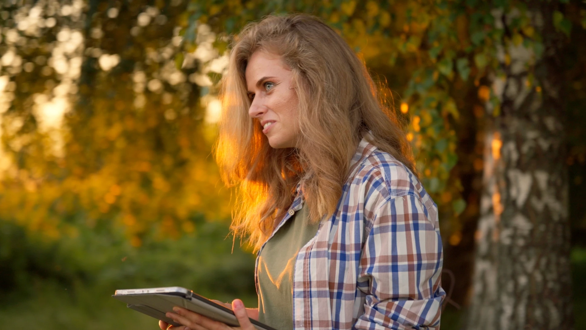 Woman with a tablet in the garden