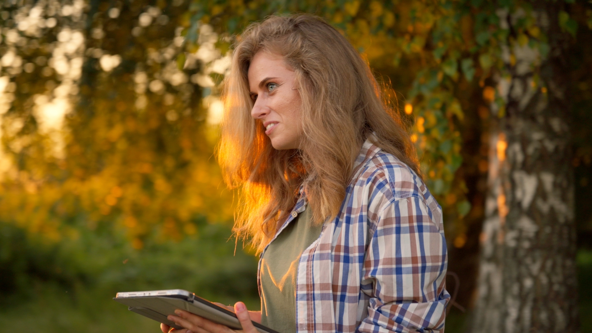 Woman with a tablet in the garden