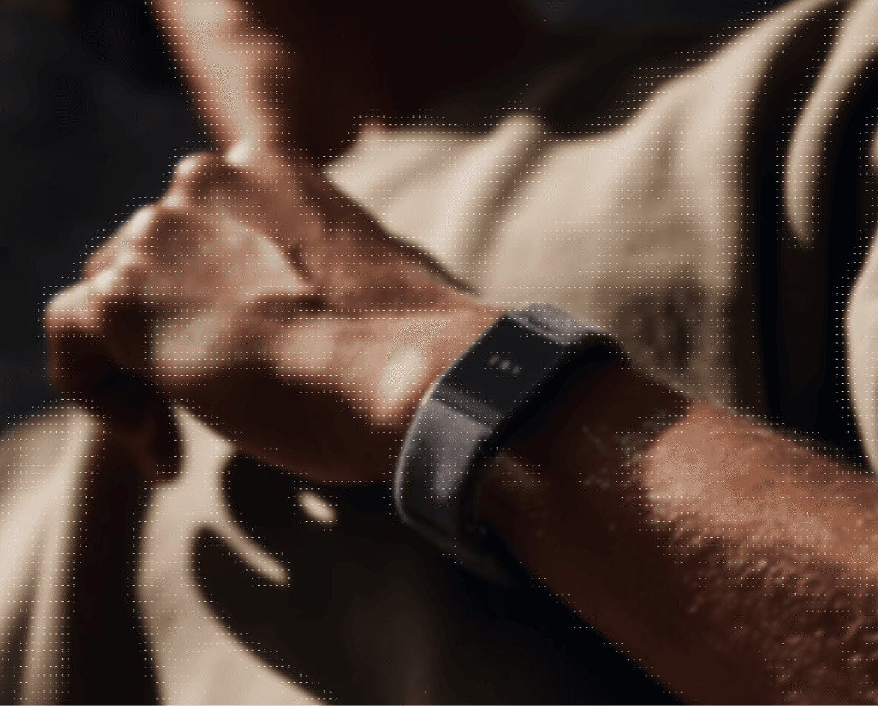 A man wearing a fitness band on his wrist, monitoring his health and activity levels.