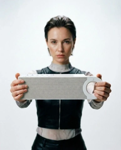 Studio portait of a man with suitcase.