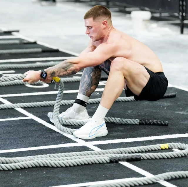 Athlete doing high rep dumbbell presses, with callouts for less fatigue and more total reps.