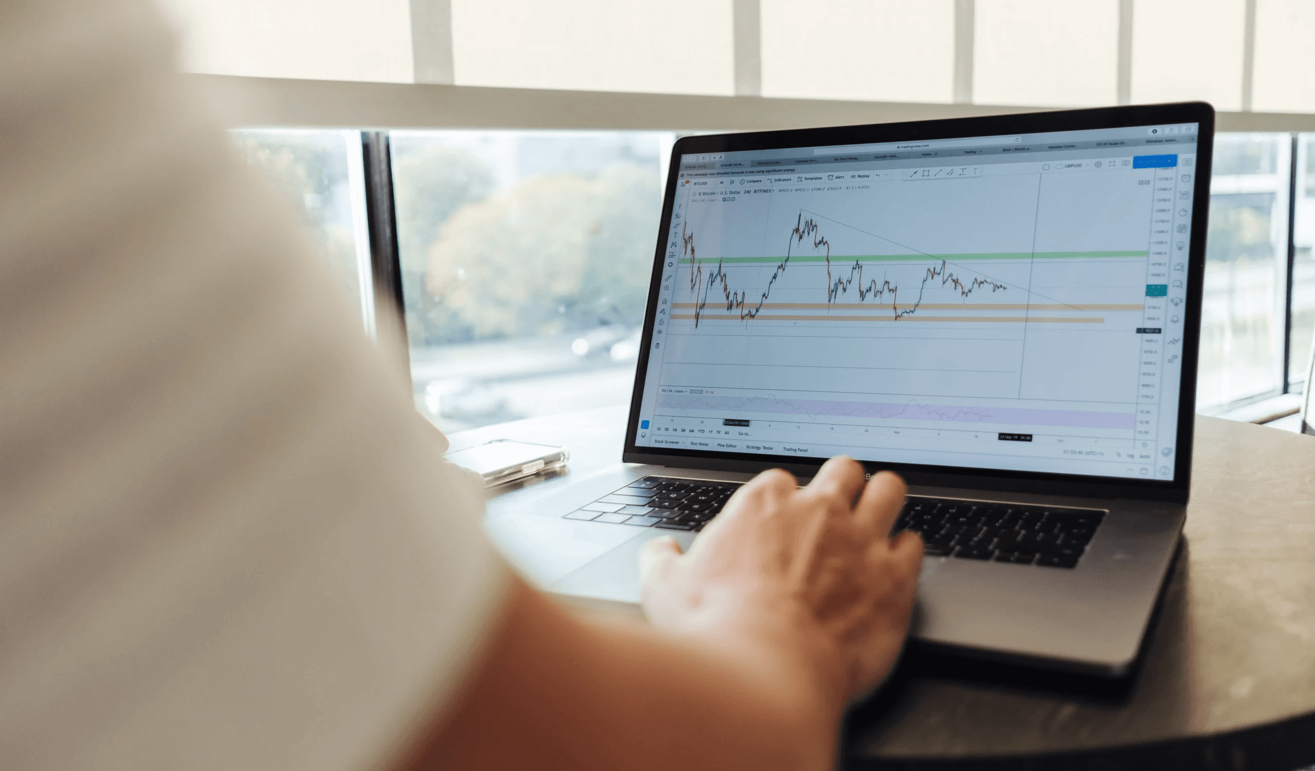 Analyzing financial charts on a laptop - Best Crypto to Swing Trade