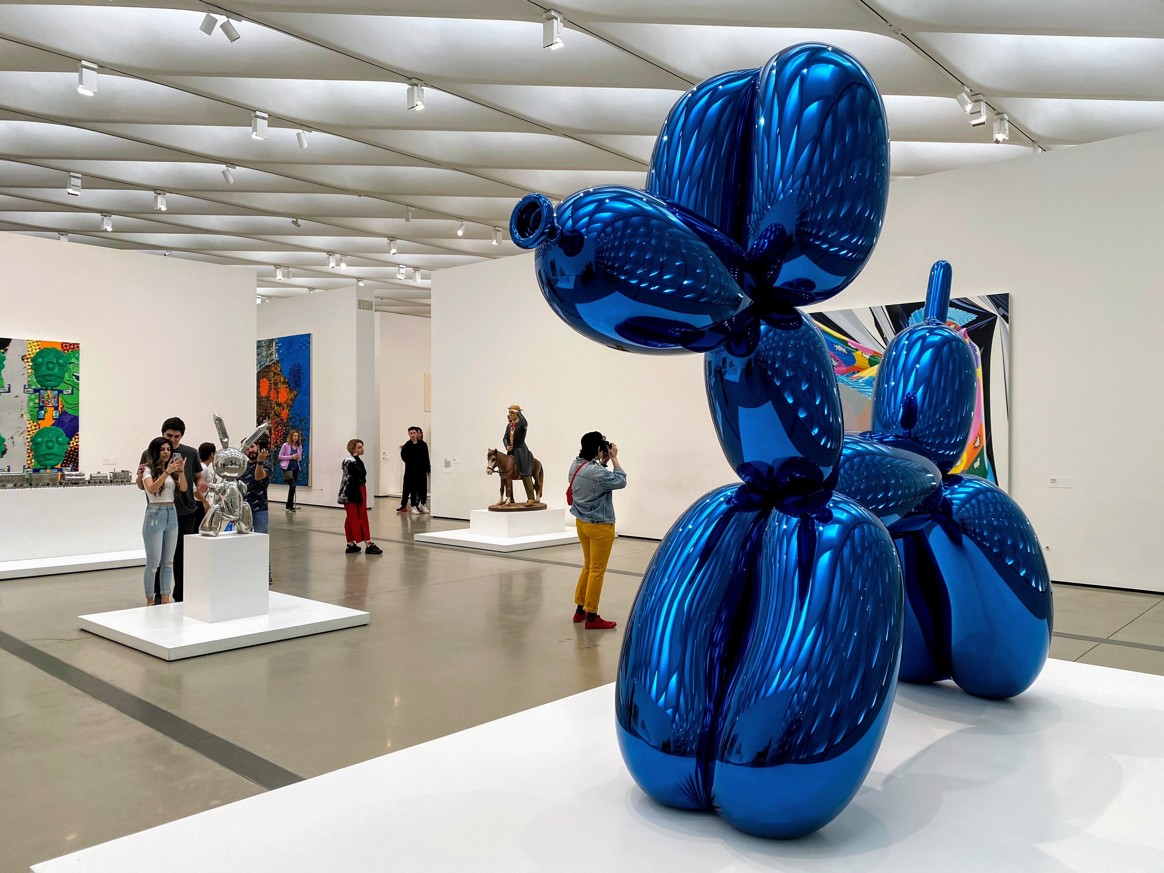 big blue inflatable baloon dog inside and art gallery