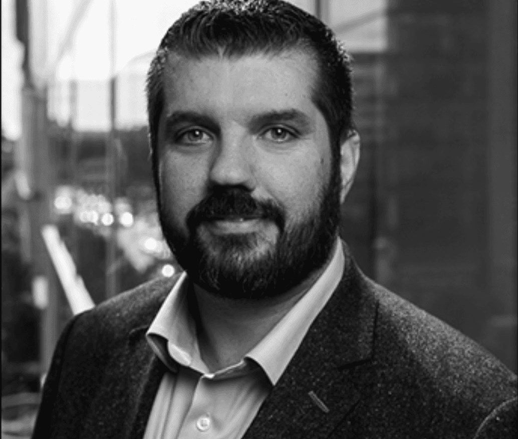 man standing beside wall