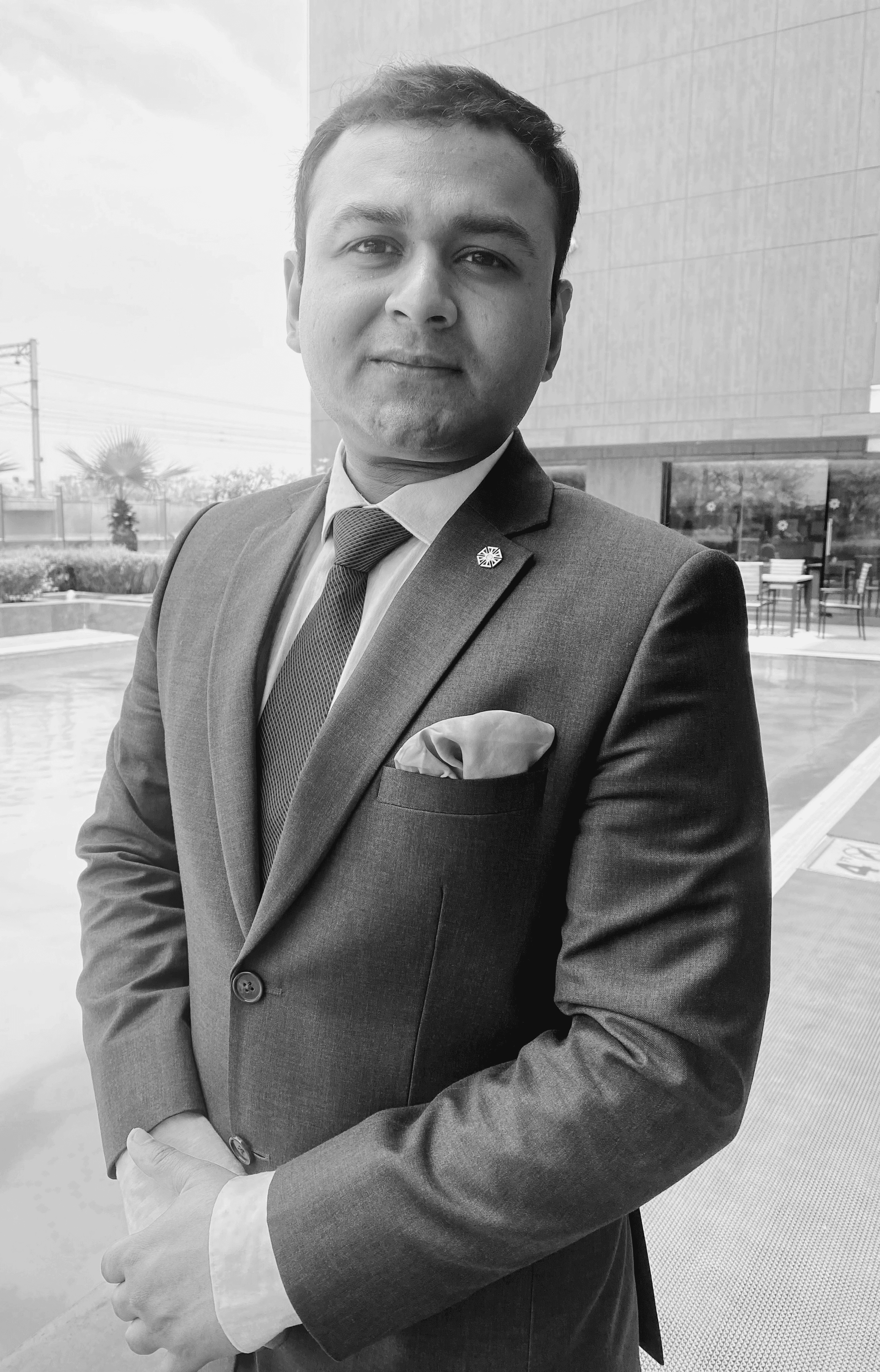 Black and white portrait of a smiling person with curly hair