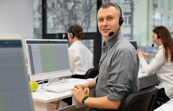 Support team in an office with headsets, showcasing BigCommerce’s reliable e-commerce support services.