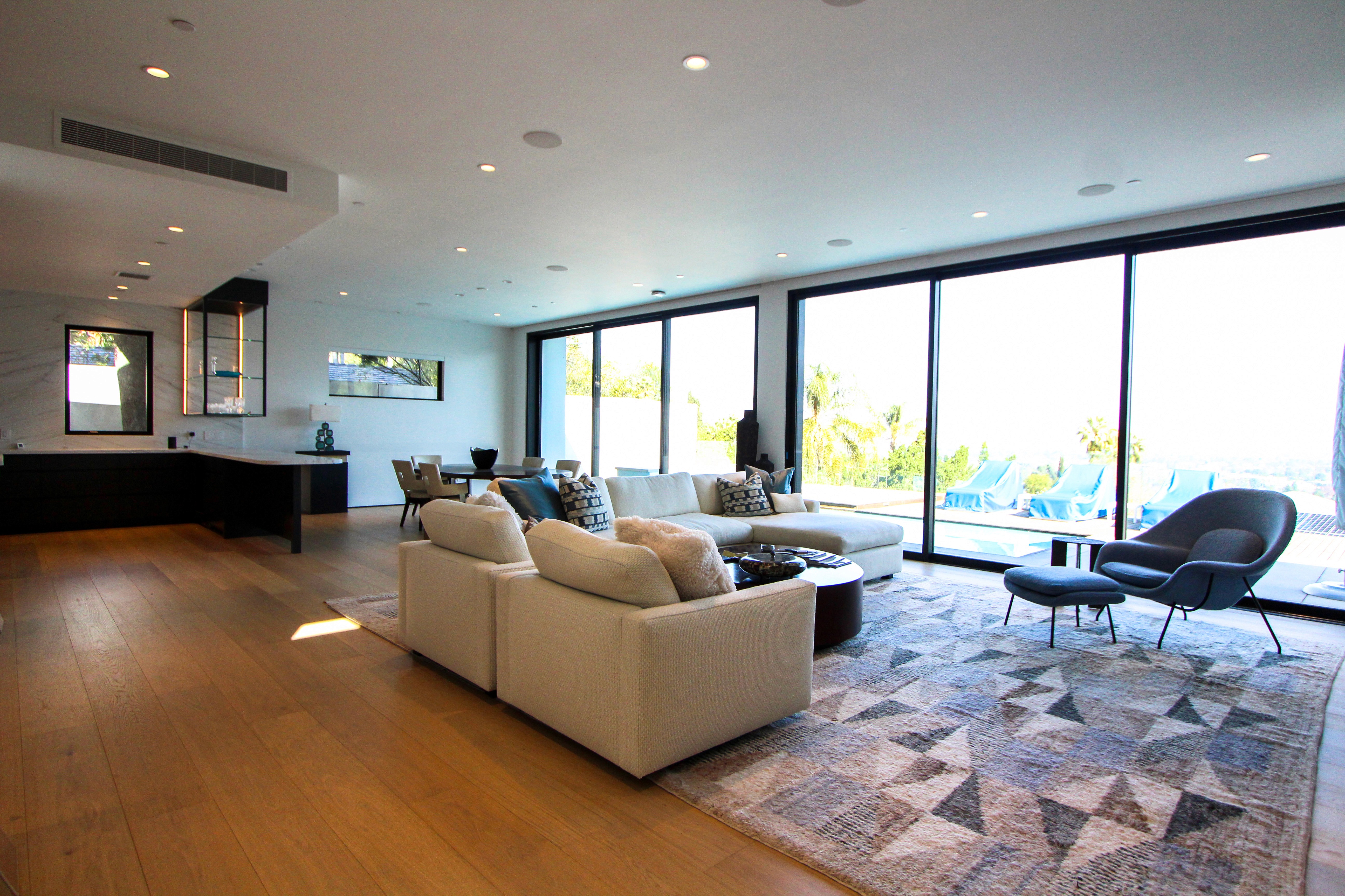 Living room featuring large glass doors opening to the outdoors.