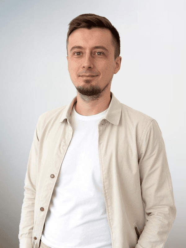 woman in white and black stripe shirt sitting on brown rock