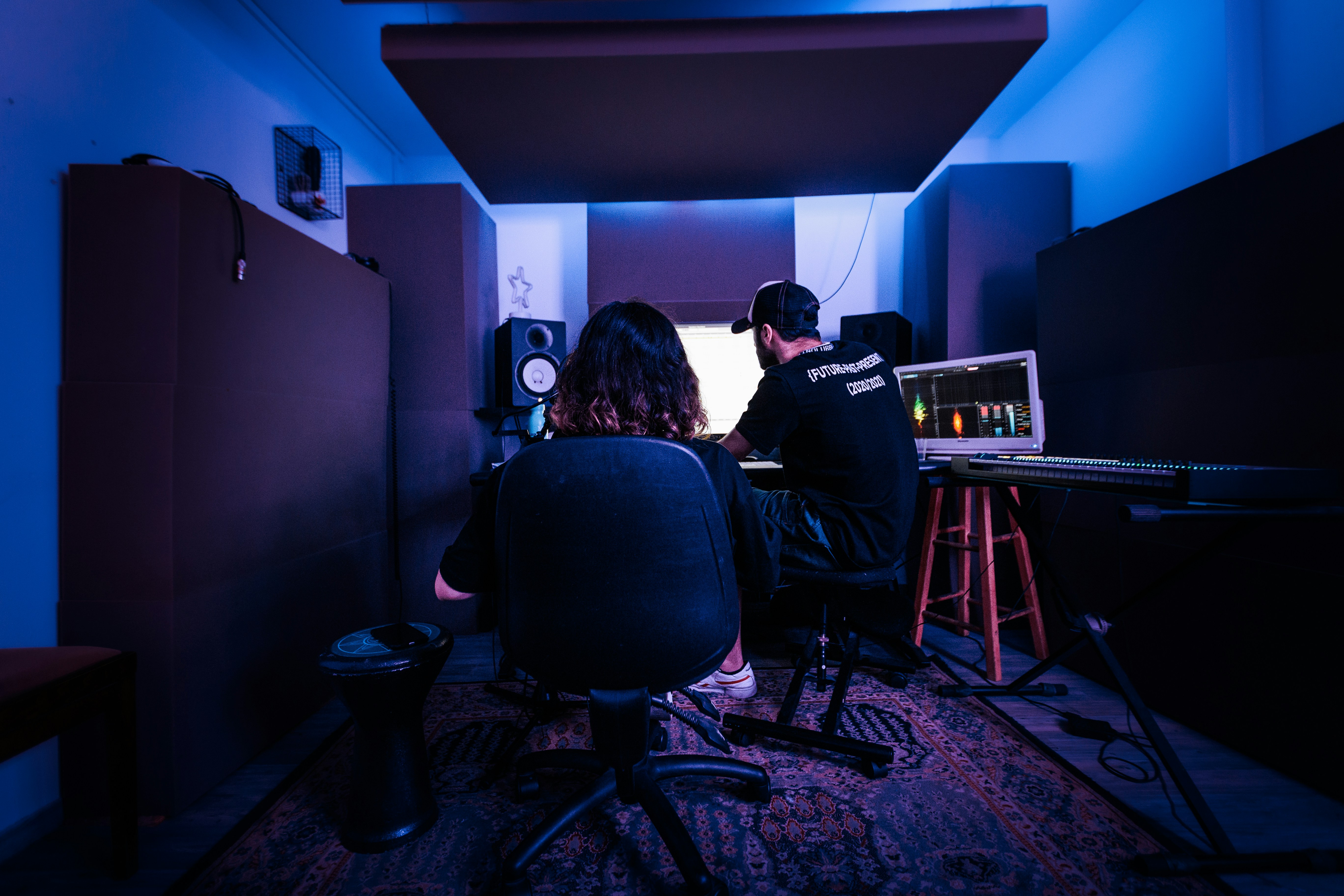 A producer and vocalist recording and creating music in a studio. Photo by BehindTheTmuna on Unsplash