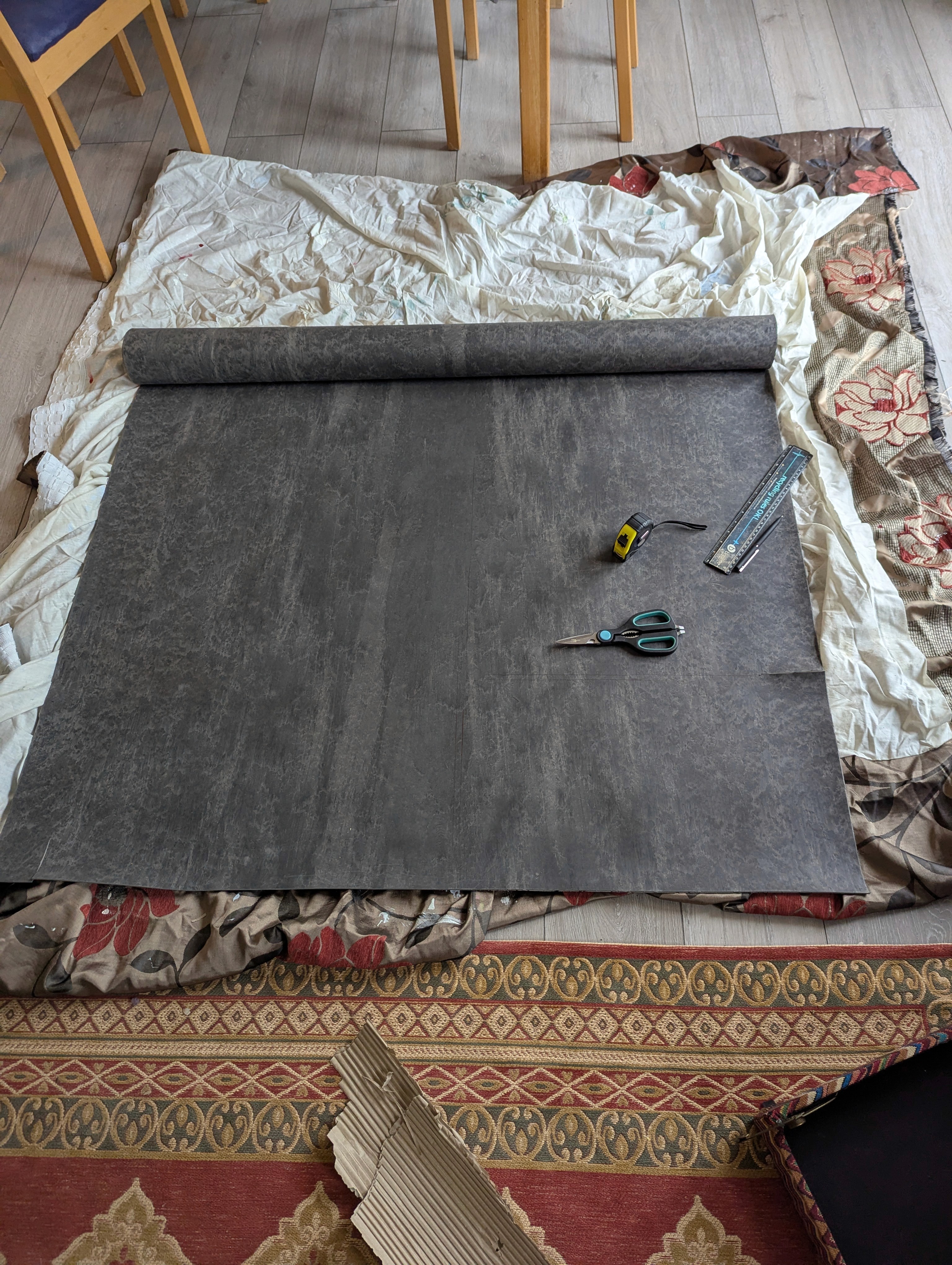 Mass-loaded vinyl laid out on the floor ready for measuring and cutting.