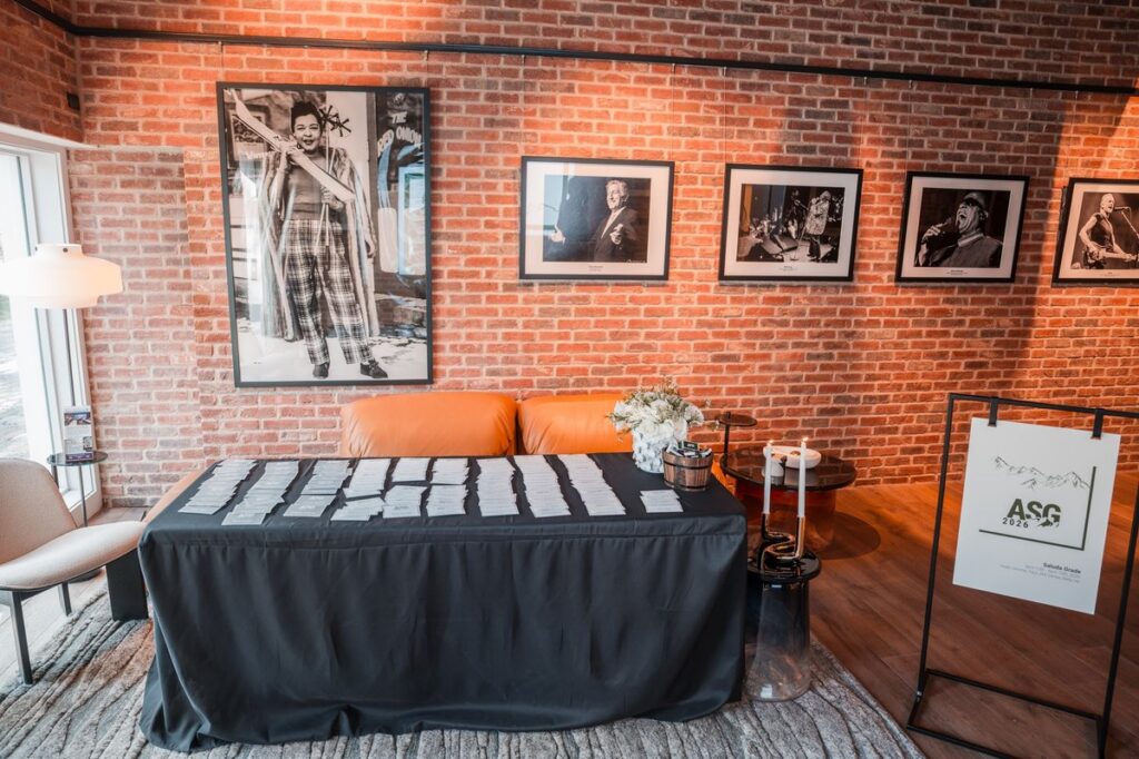 Registration table beneath a wall of framed photographs