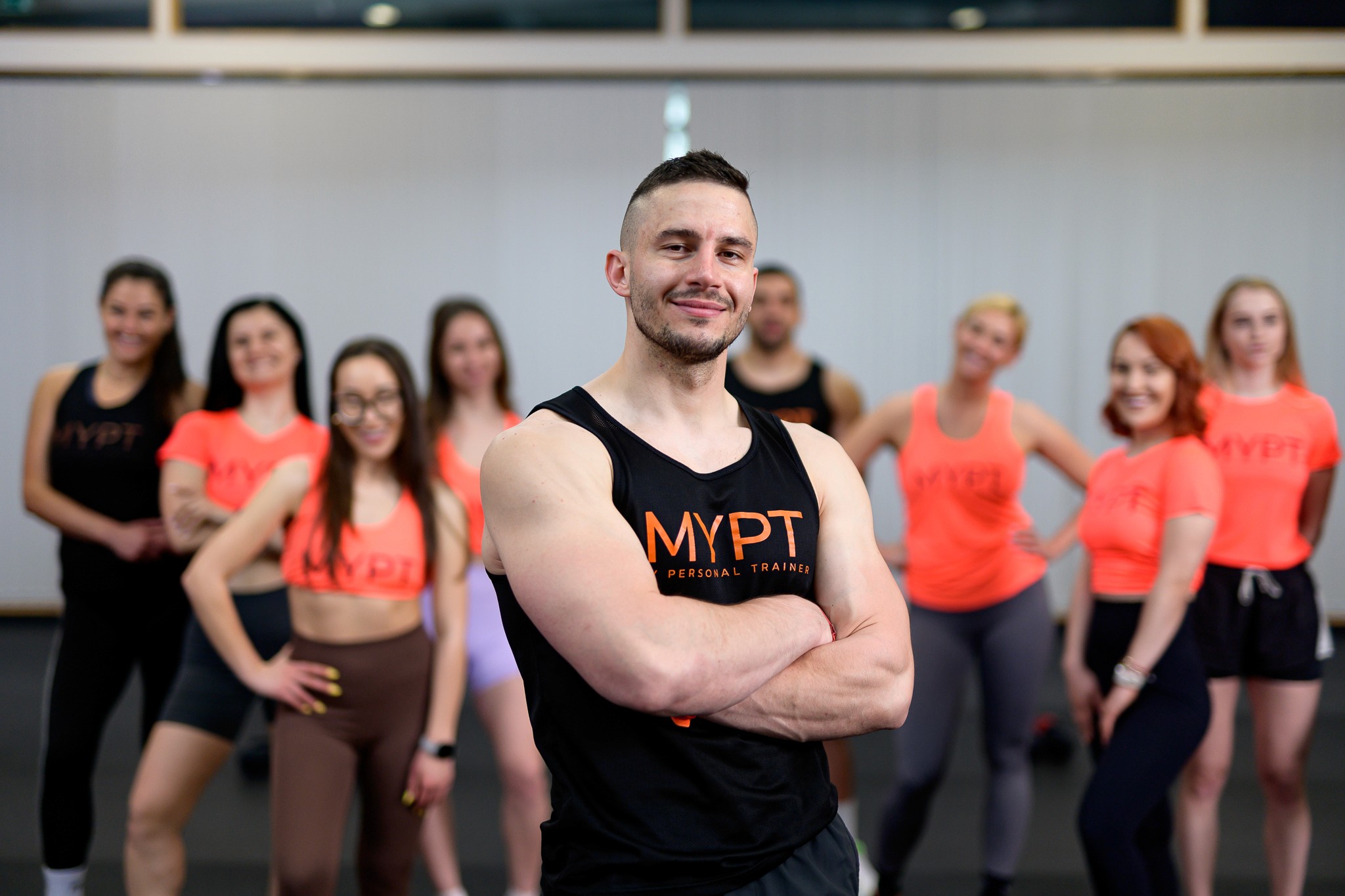 A man with ear buds in a gym