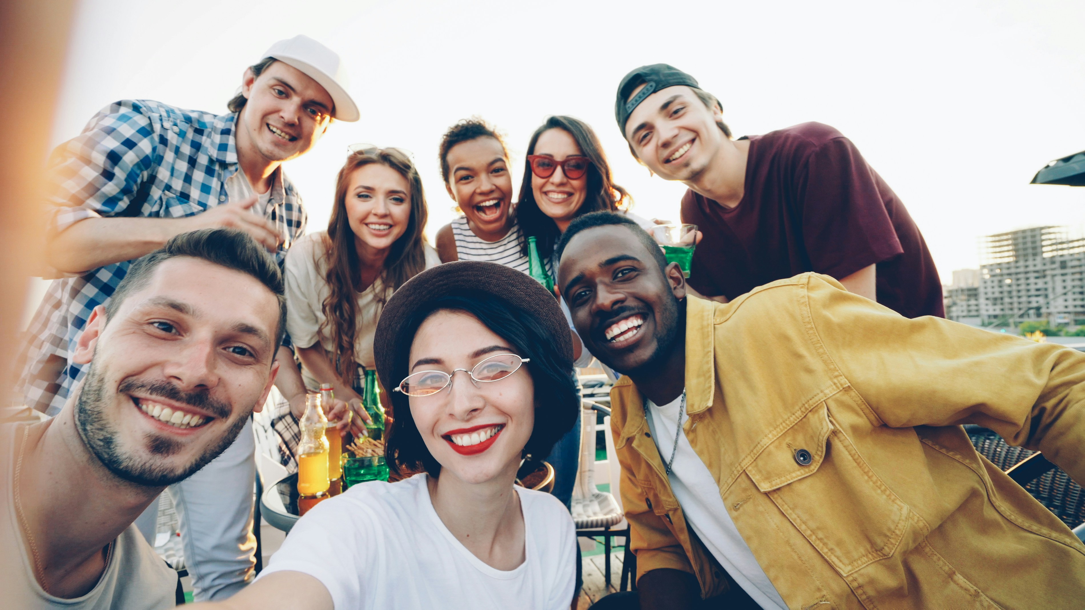 A diverse group of friends taking a selfie outdoors.