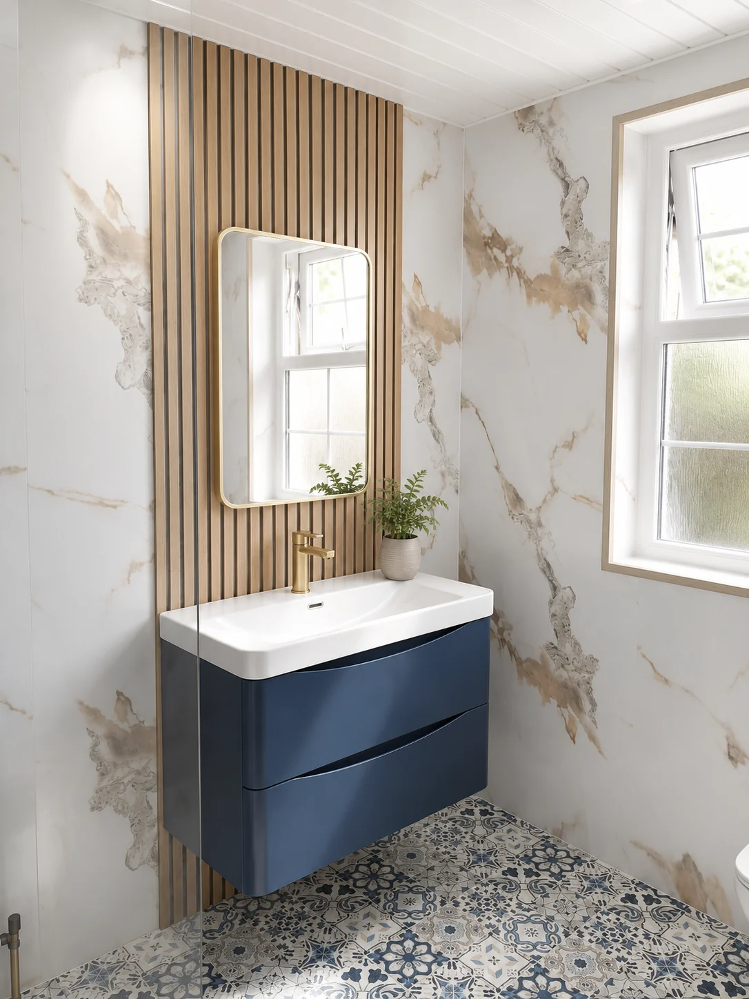 Modern bathroom with a dark blue curved vanity unit, brushed brass brassware, marble effect wet wall panels, oak slatted feature wall and patterned mosaic flooring