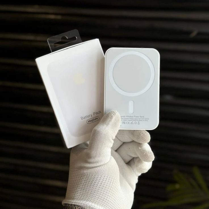 Close-up of a man’s legs wearing white and blue athletic sneakers, stepping through a field of yellow wildflowers under a partly cloudy sky.