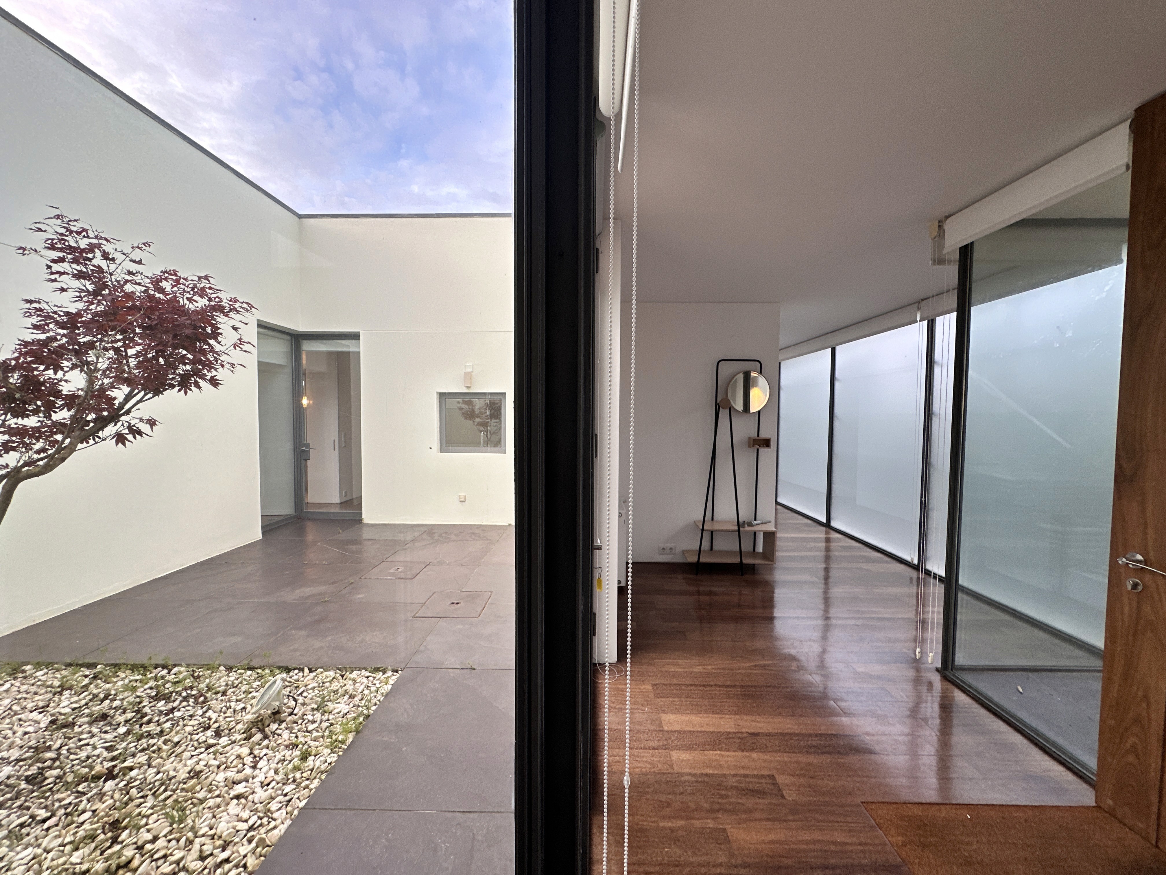 Modern hillside house with stilts and glass railing