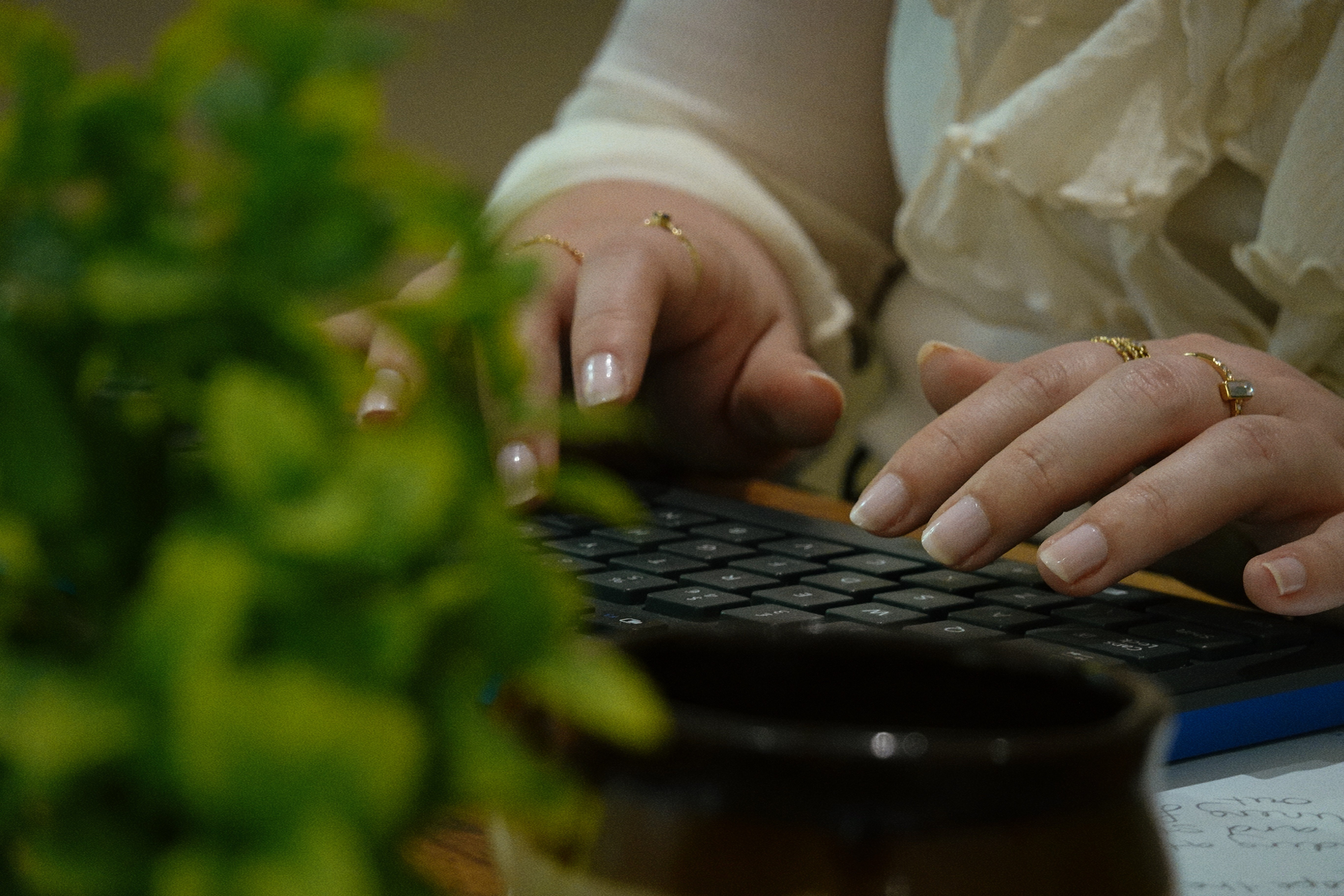 woman in wedding dress while holding flower during daytime