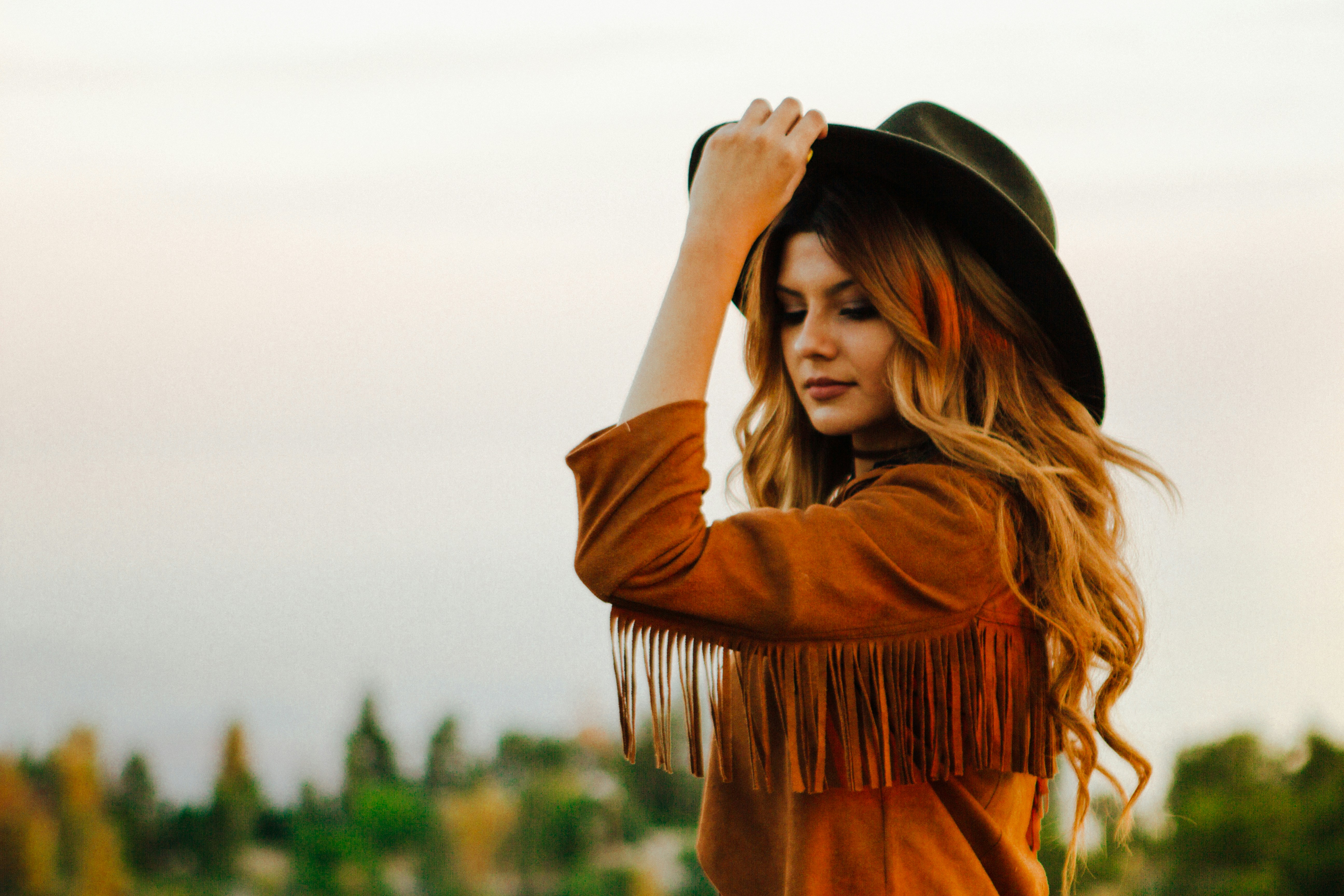 woman posing with hat on - Autumn Vs Spring Color Analysis