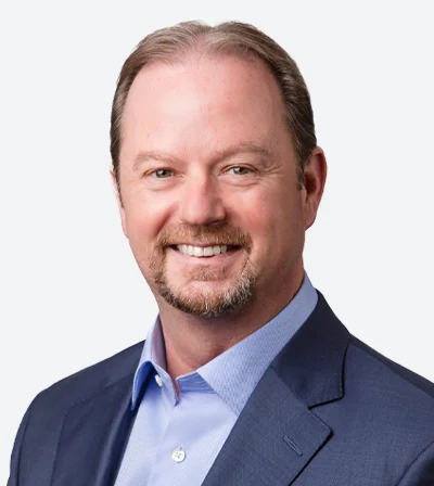 ACCEL Law Group CEO in a blue suit, smiling in a studio headshot